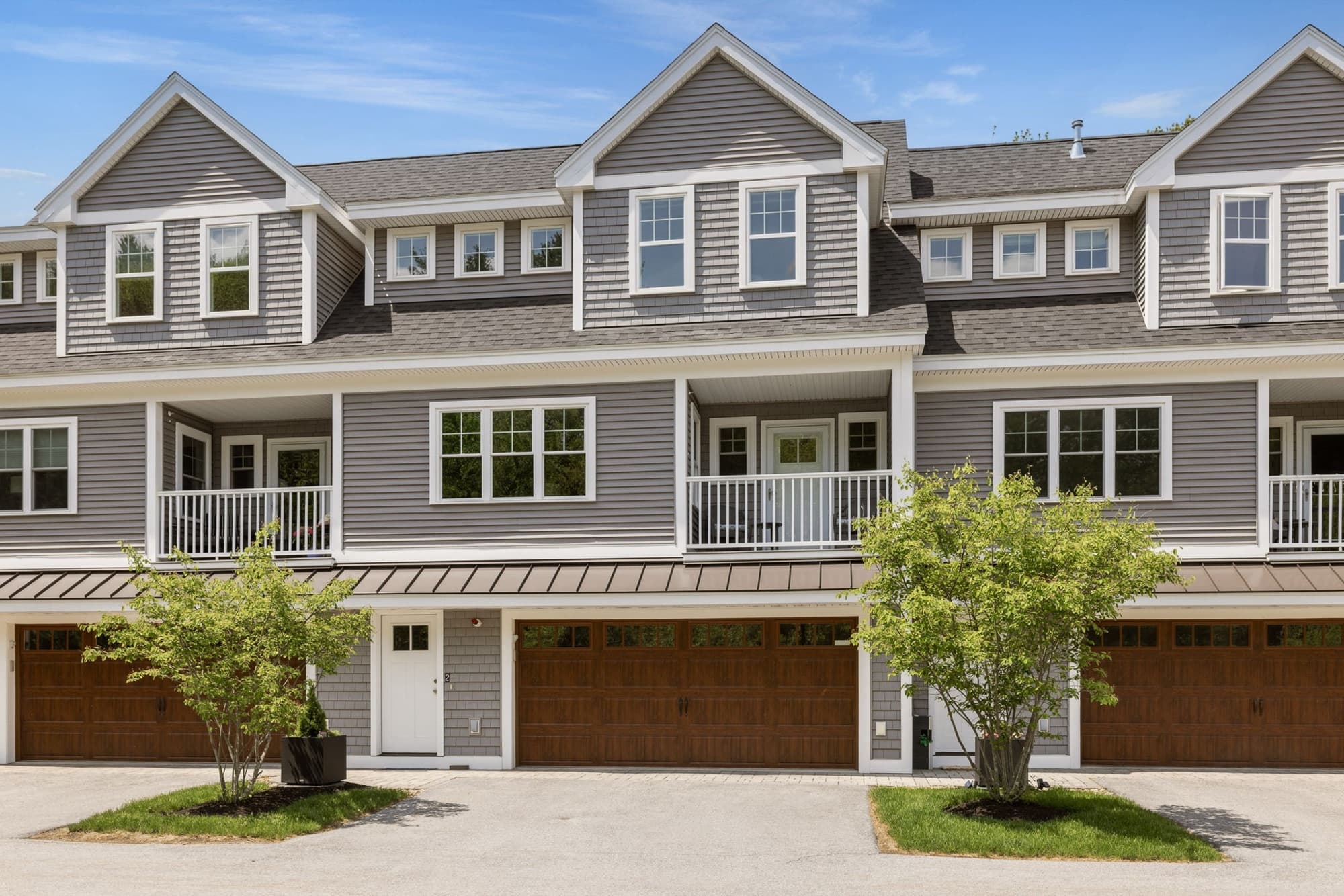 Street view of the gray Peverly Hill Estates townhouse row